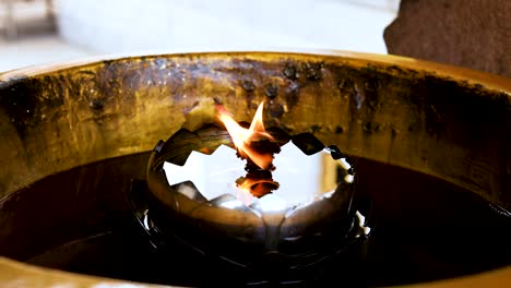 a flickering flame in a temple setting