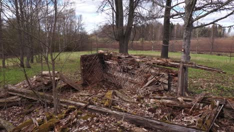 destroyed old homestead surrounded by trees in gimbal backward view