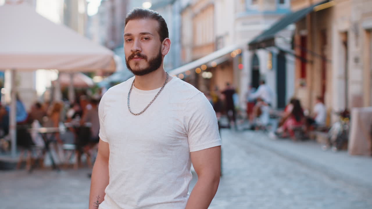 Happy young man showing thumbs up like sign positive something good positive feedback in city street