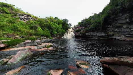 Cámara-De-Acción-Extremadamente-Ancha-Que-Se-Inclina-Hacia-Arriba-Desde-Las-Rocas-Y-Revela-La-Impresionante-Cascada-Del-Pozo-Del-Diablo-En-El-Hermoso-Parque-Nacional-Chapada-Diamantina-En-El-Noreste-De-Brasil-En-Un-Día-Nublado