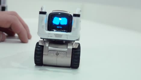 child interacting with a small robot toy