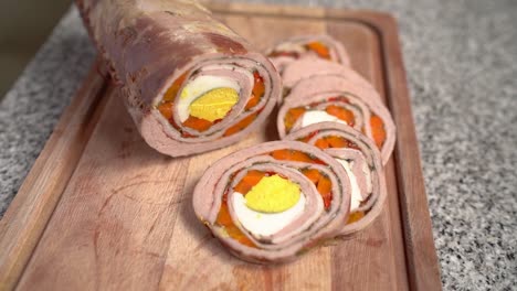 Slices-of-Stuffed-Flank-Steak-Arranged-on-a-Wooden-Cutting-Surface---Close-Up-Pullback-Shot