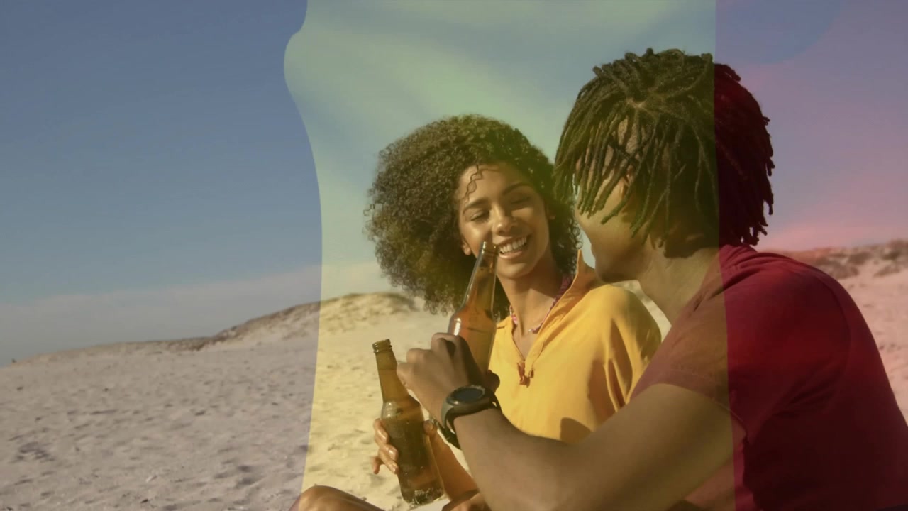Man and woman opening beer with opener passing bottle sipping gazing horizon for beach lifestyle