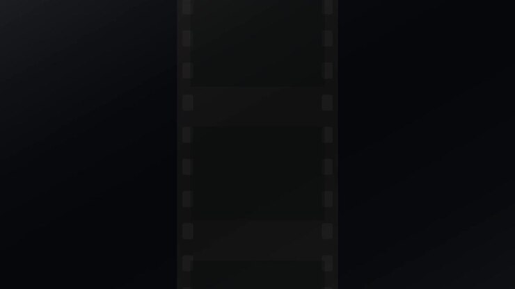 Vertical Film Strip Moving Against Dark Background
