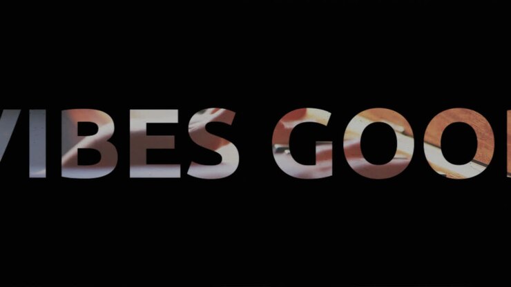 Animation of vibes text in black and white letters over child playing the piano