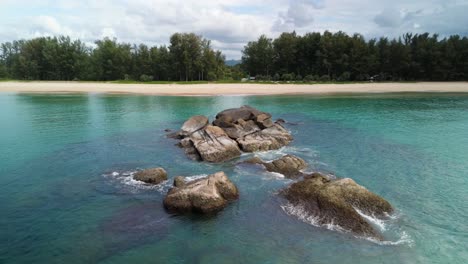 Rock-Formations-Clear-Blue-Tropical-Water-at-Stunning-Bor-Dan-Elephant-Rock-Beach-Natai-Phang-Nga-Phuket-Tourist-Destination,-Hidden-Paradise-along-the-Andaman-Coast