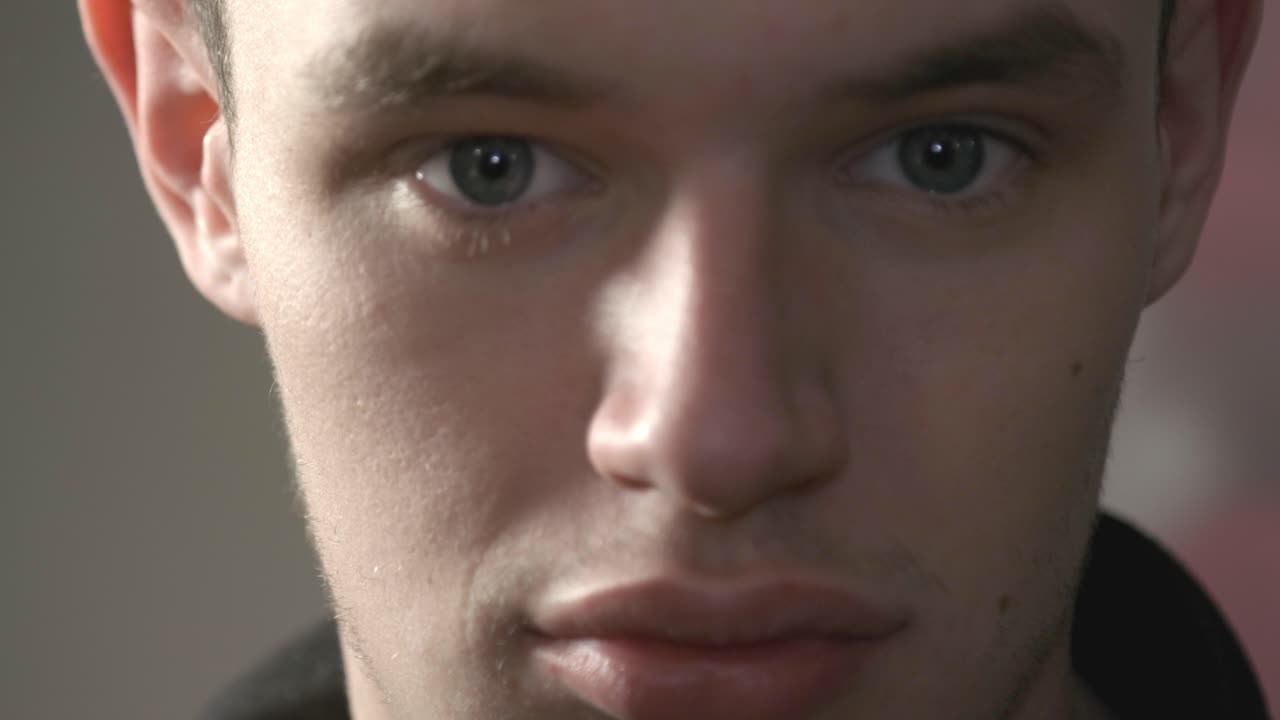 A Young Man Wearing Eye Glasses While Looking Straight To The Camera - Close Up Shot