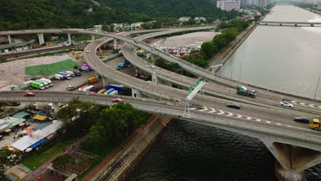 busy traffic on highway over a wide waterway bridge in, hongkong, china