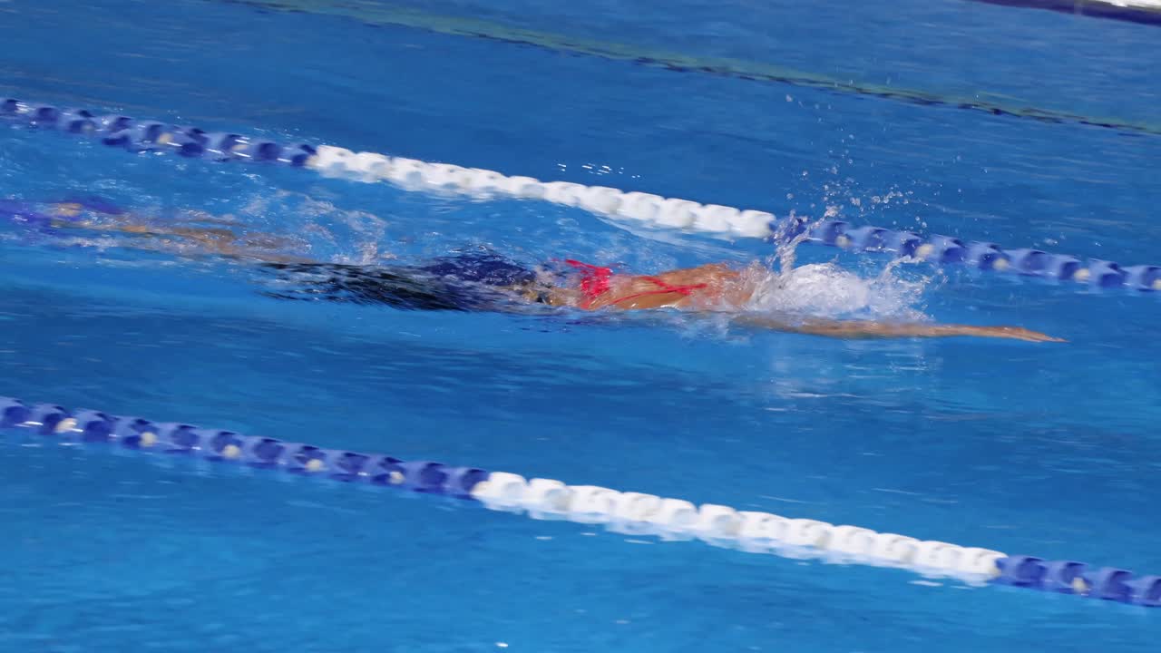 Swimmer competes in a freestyle swimming race