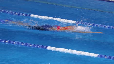 swimmer competes in a freestyle swimming race