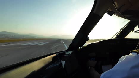 Immersive-cockpit-scene-of-a-real-time-take-of,-left-side,-from-a-jet-cockpit-taking-off-with-a-blinding-sun-ahead-at-sunrise