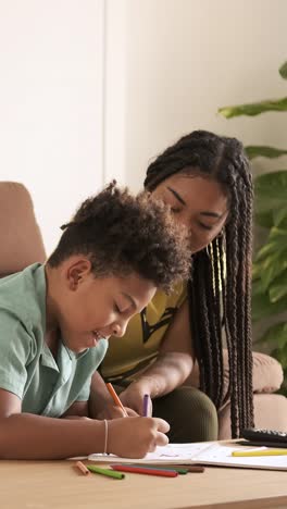 mother and son drawing together at home
