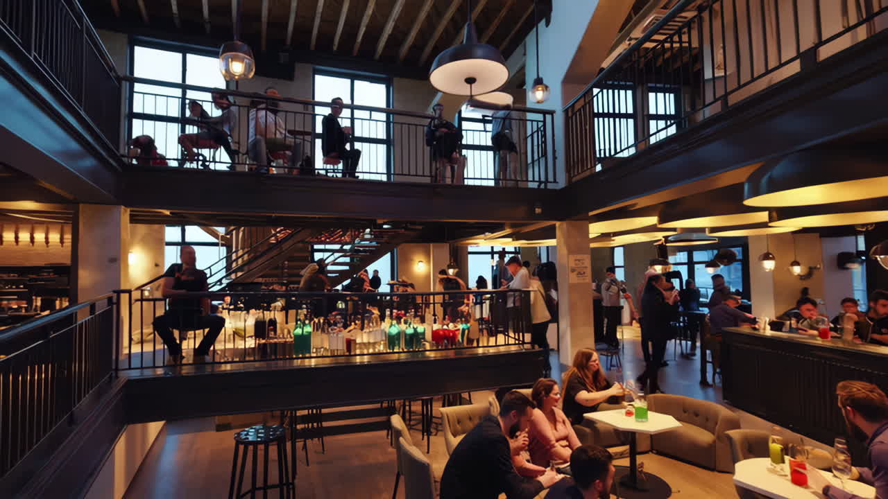People socializing in a modern, multi-level bar or lounge
