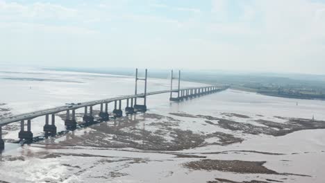 circling drone shot of prince of wales bridge over severn estuary