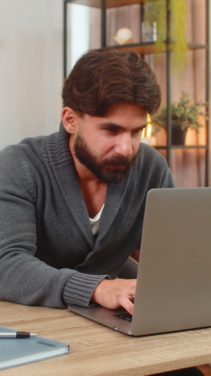 Indian man gets email partnership confirmation on laptop smiles thumbs up celebrates win happy news