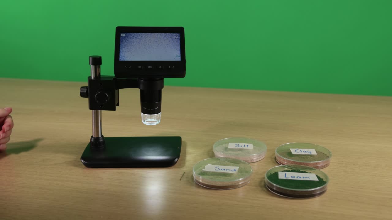 Microscope examines soil samples on laboratory table