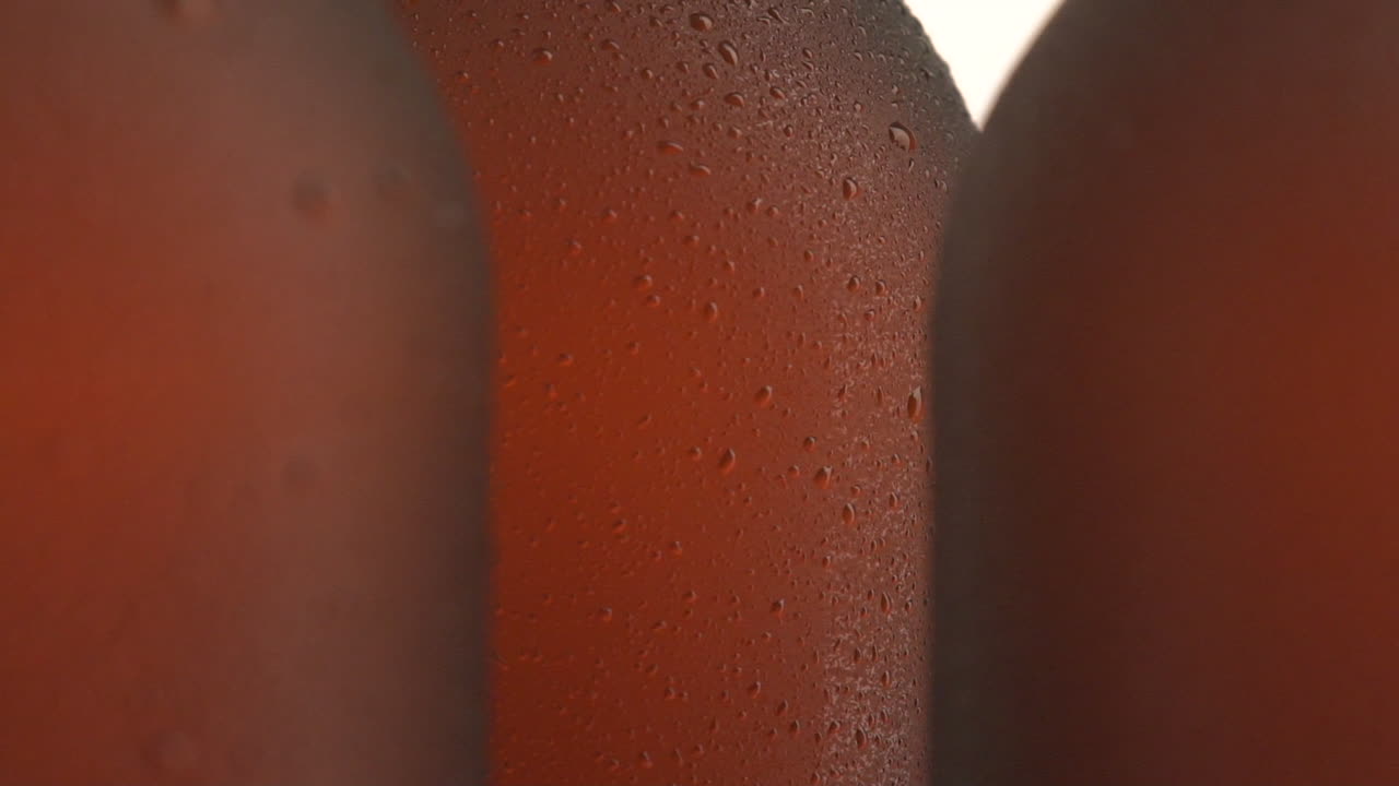 Three beer bottle rotating on white background
