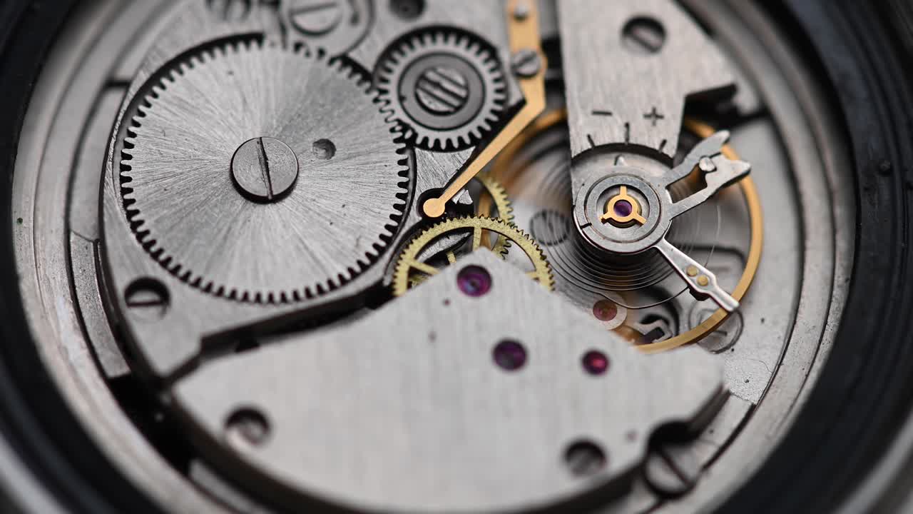 Internal working mechanism of the wristwatch with a rapidly rotating pendulum and gears. 4k clock close up with shallow depth of field