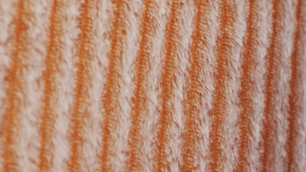Detailed orange and white striped textured fabric, ideal for textiles and patterns. Perfect for apparel and crafts