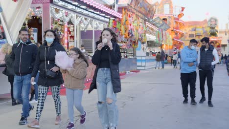 Family enjoying a winter fair with cotton candy