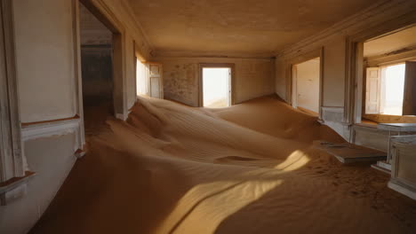 desert sands reclaiming an abandoned room in kolmanskop