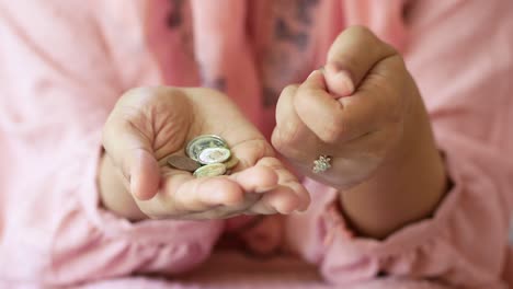 woman holding coins in her hands