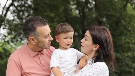 a man and a woman hold a little boy their child in 4k 2025 08 04 20 45 53 utc.mov | beautiful, care, carefree, child