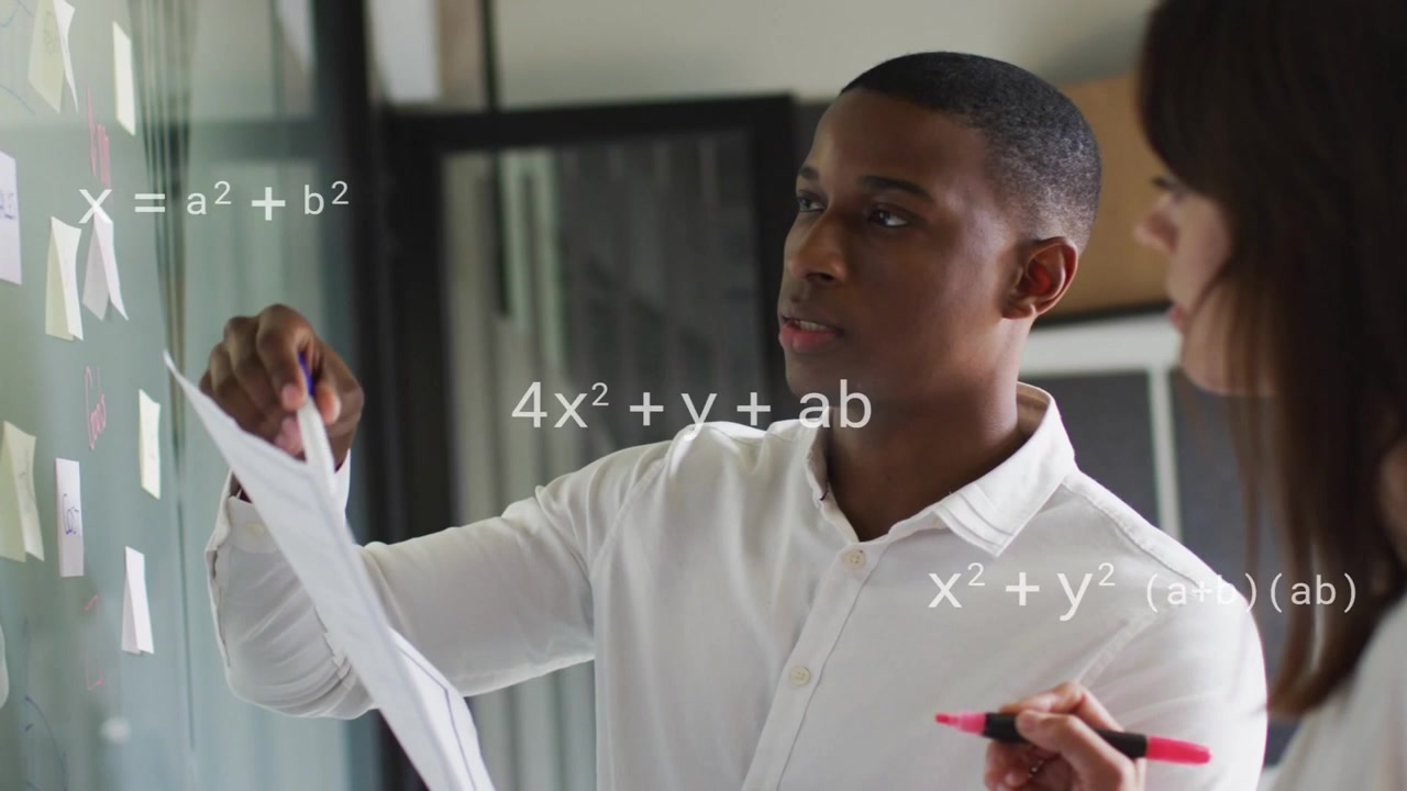 Man checking pages, woman annotating glass while animated formulas marking notes for business plans