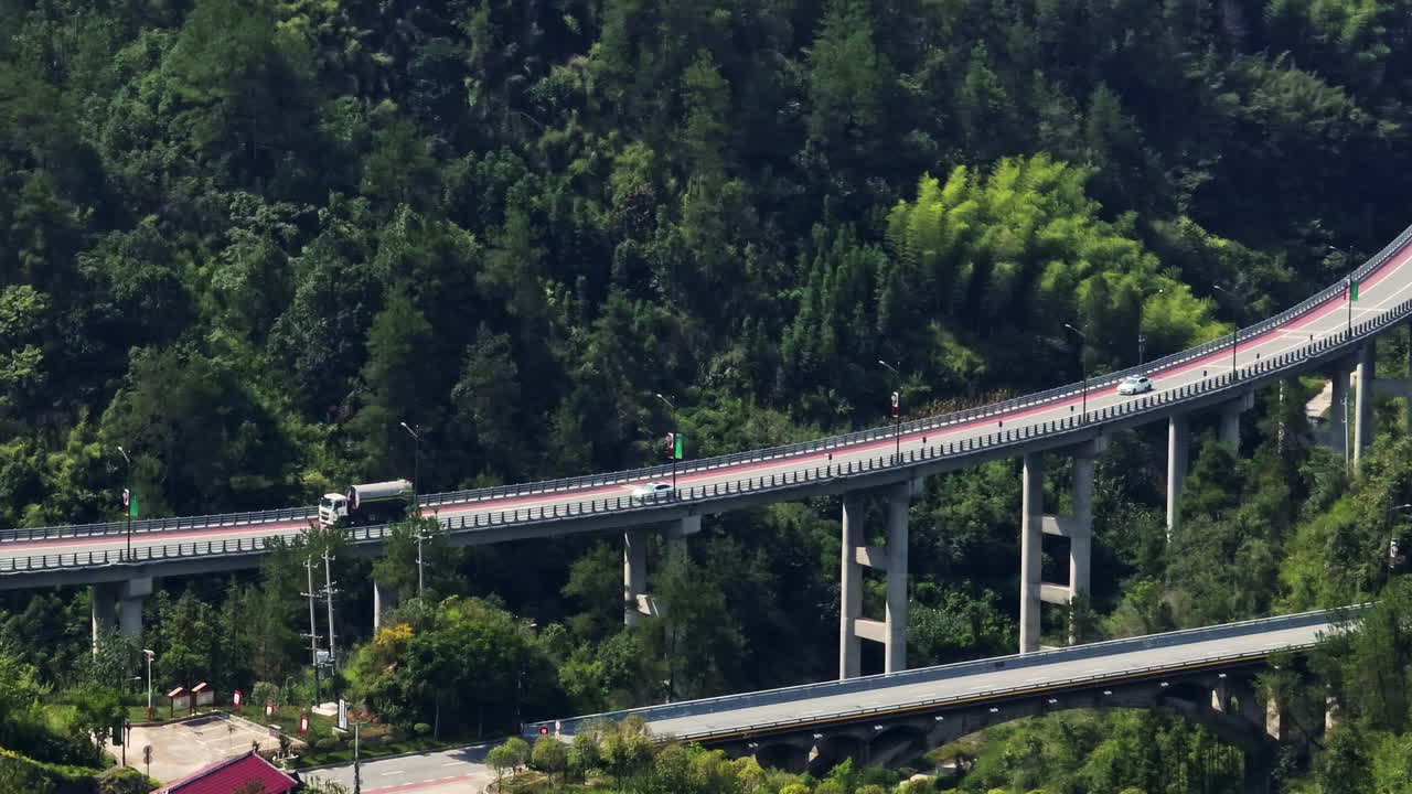 Telephoto drone shot of traffic on highway bridge, in rural China, sunny day