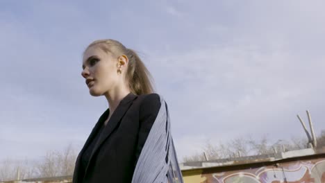 woman in black jacket against a blue sky