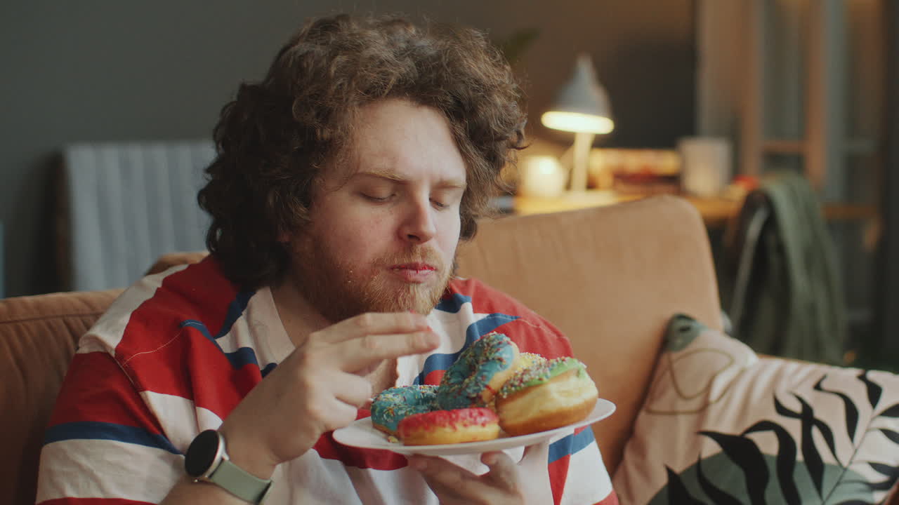 Man Eating Donuts on the Couch