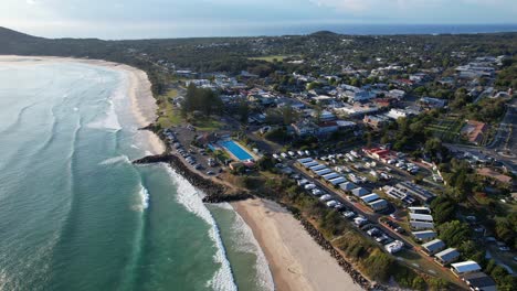 byron bay swimming pool and beachfront hotels - byron bay beach during sunrise in nsw, australia