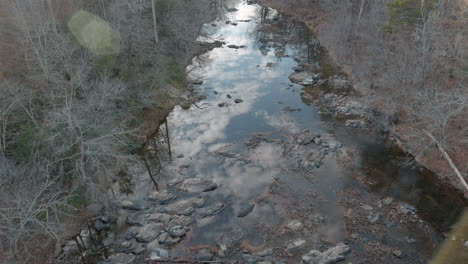 aerial establishing eno river flowing through forest in fall, nc usa