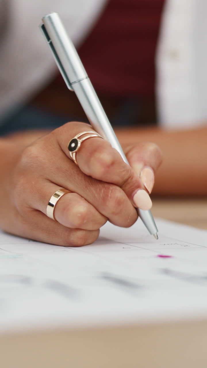 Close-up of a Woman's Hand Writing on a Calendar