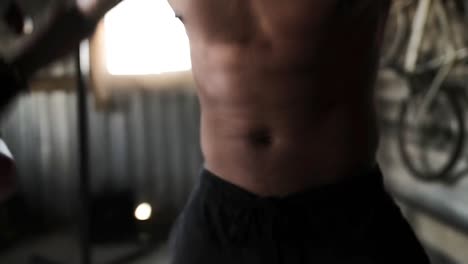 boxer wearing boxing gloves flexing in the gym