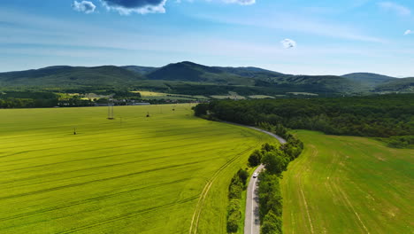green fields and hills in europe. vibrant green fields stretch across the landscape under a clear blue sky in a serene european countryside setting