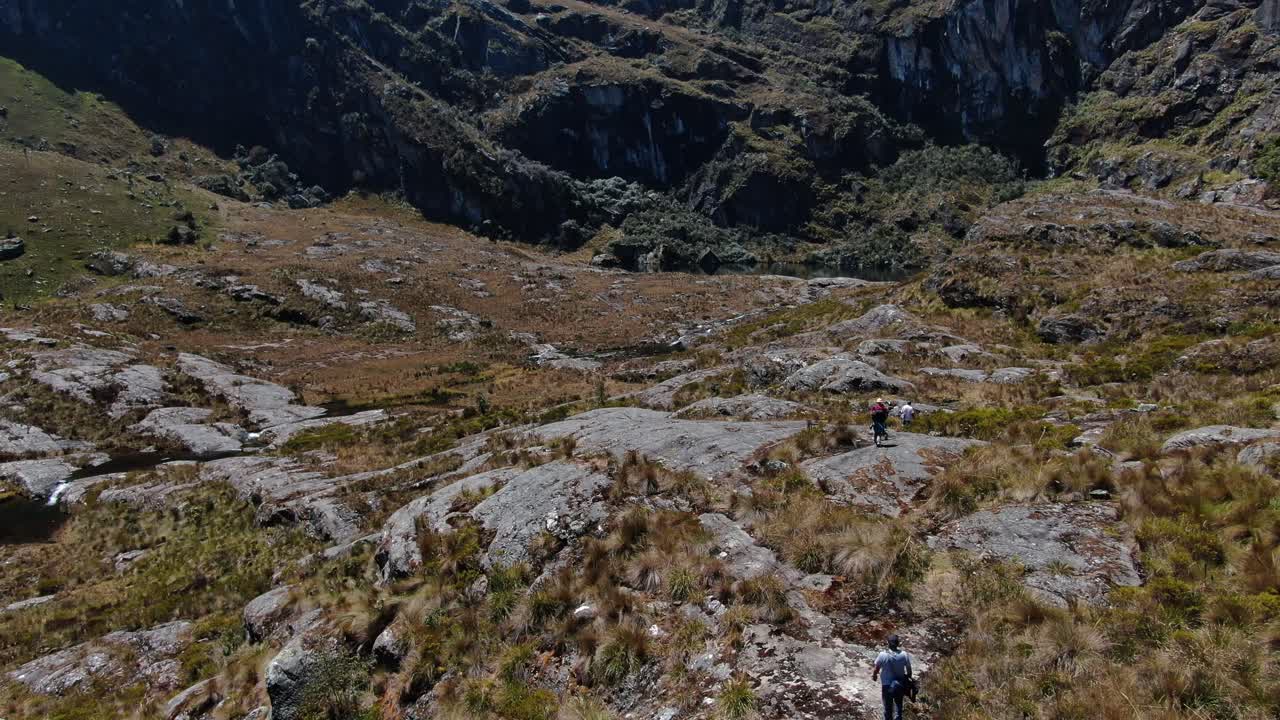 Tourist hiking at The Lagoons of Pichgacocha from Ambo, Huanuco in Peru. Steady wide 4k drone footage.
