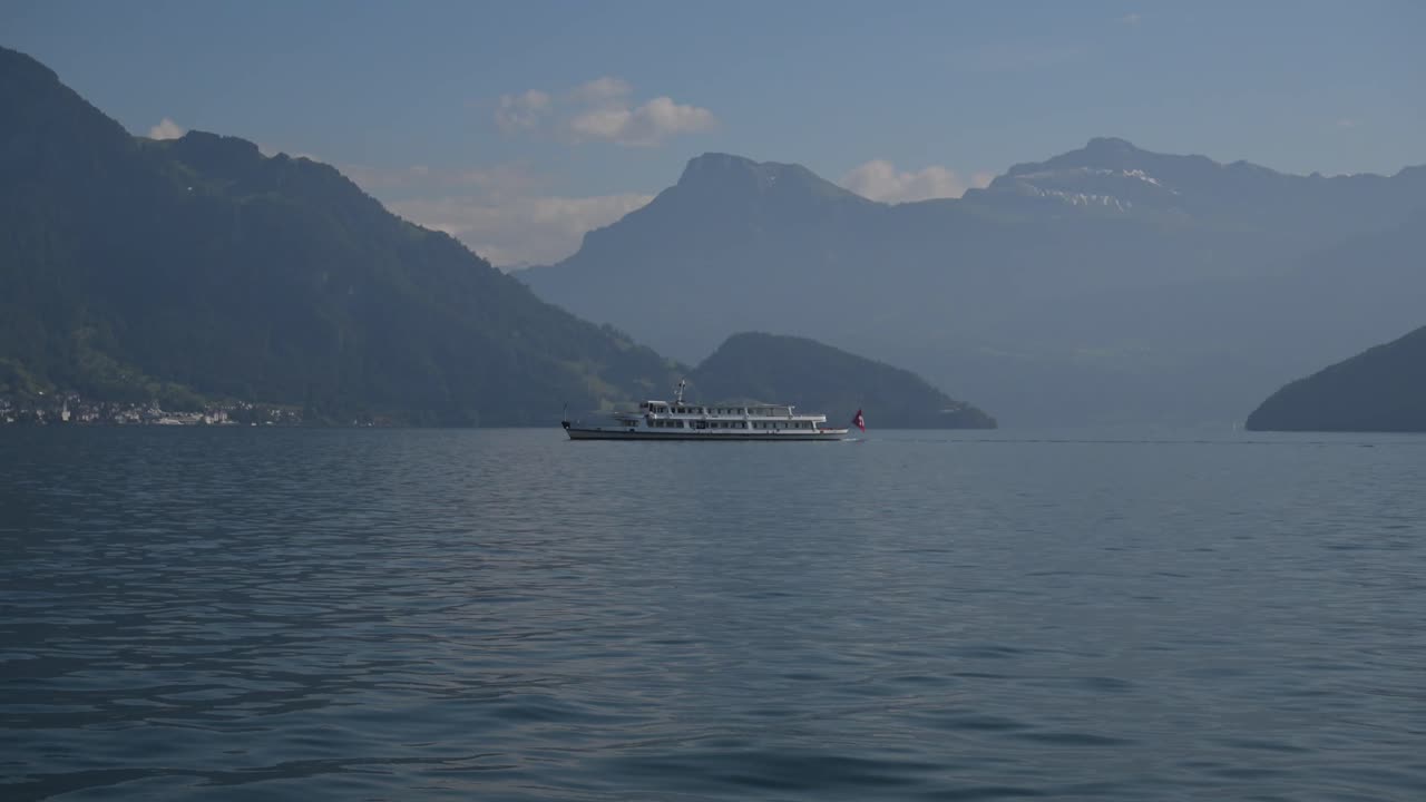 Stunning View of a Boat on a Lake Surrounded by Mountains