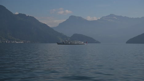 stunning view of a boat on a lake surrounded by mountains