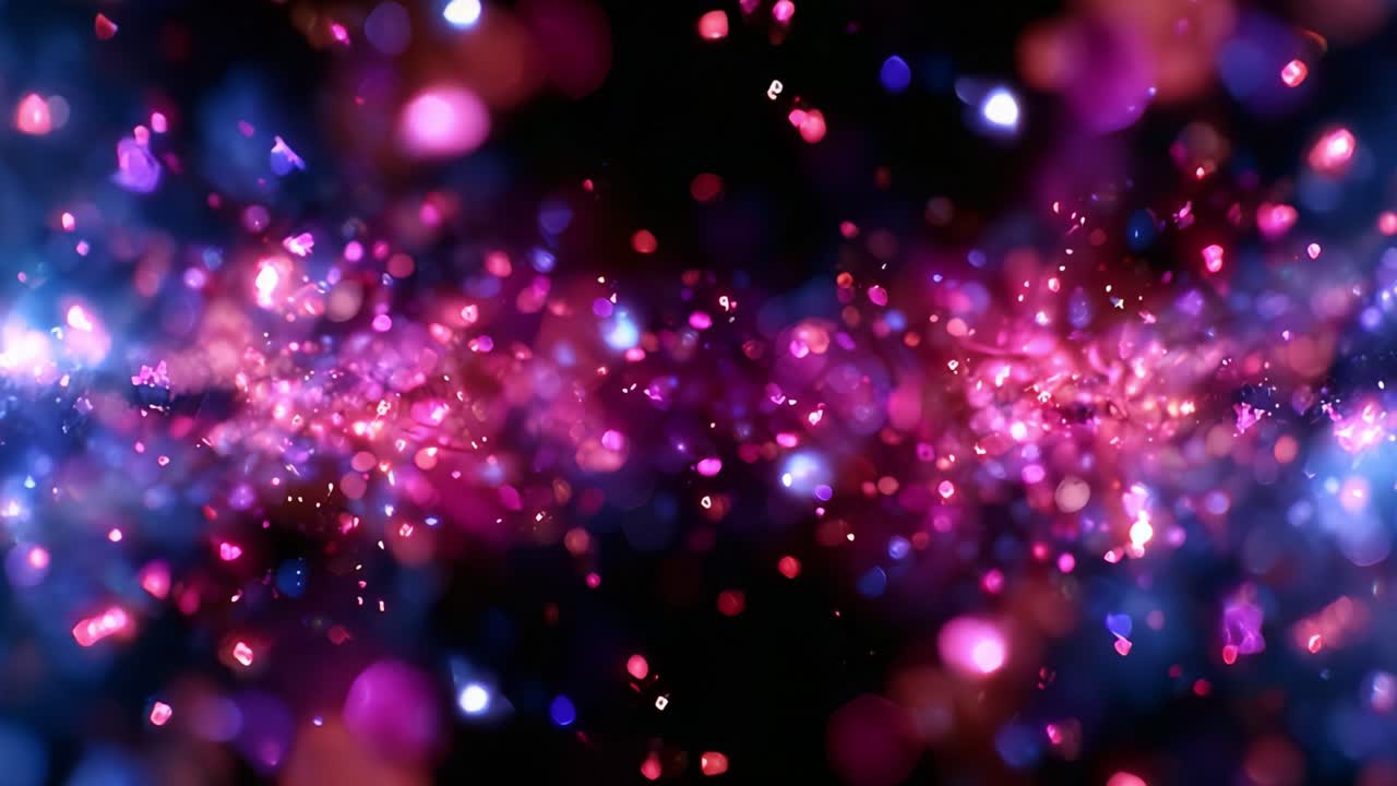A captivating visual experience showcasing a dynamic burst of colorful light particles, creating a mesmerizing interplay between hues of pink, purple, blue, and shimmering stars against a dark backdrop