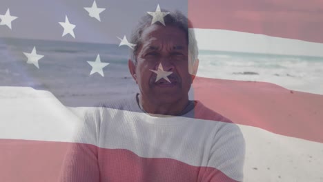 animación de la bandera de los estados unidos de américa y retrato de un hombre biracial en la playa.