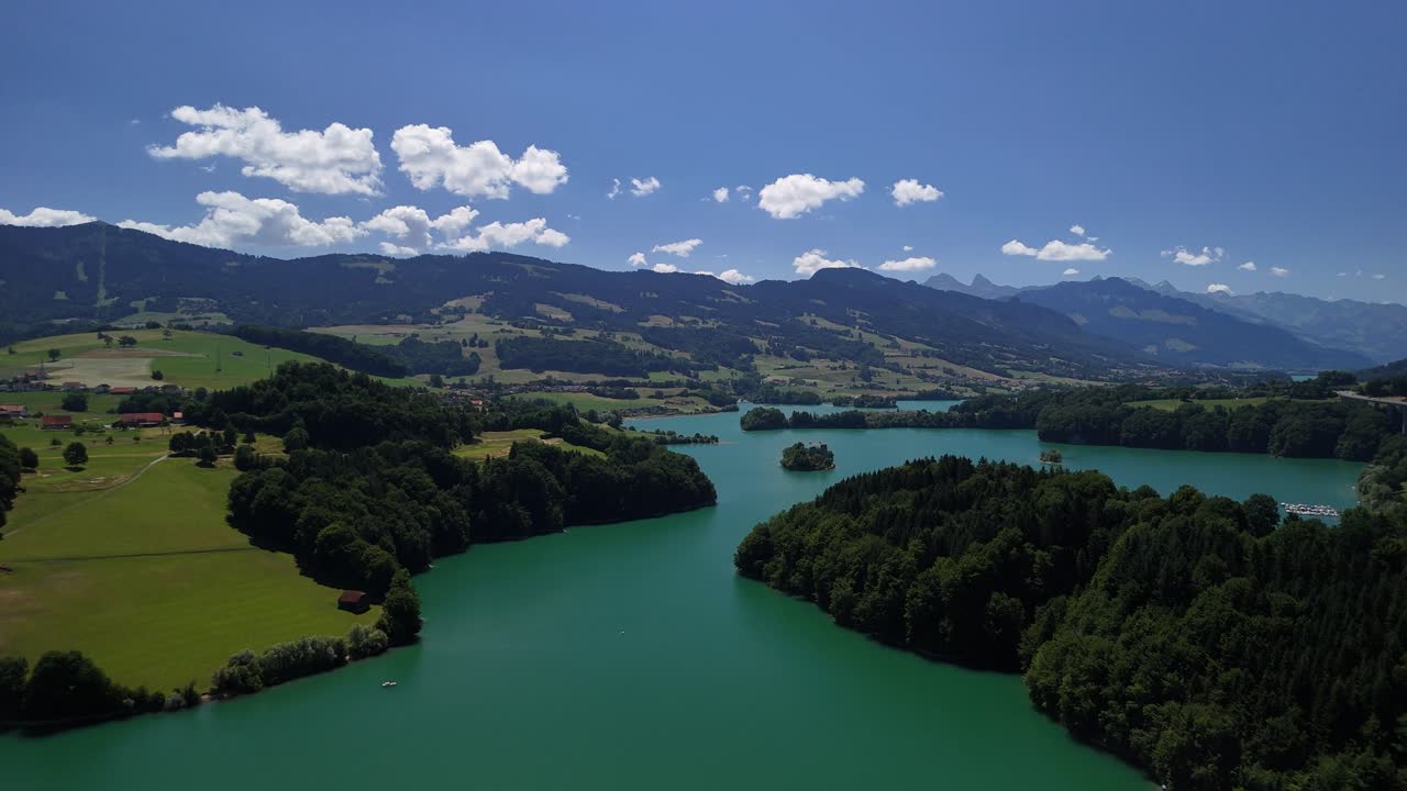 Le Bry small island on Lake Gruyère Switzerland aerial drone turquoise blue water