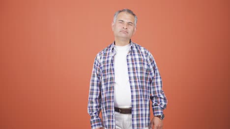 man looking at camera with dull expression.