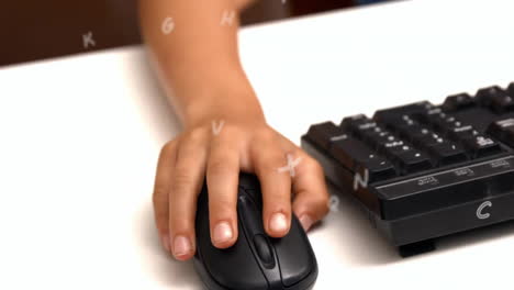 animation of letters over hand of biracial schoolboy using computer mouse at school