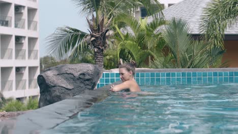 young-lady-relaxes-and-swims-in-transparent-blue-water