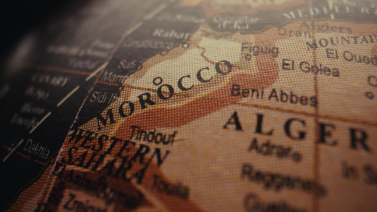 Close-up of a world globe highlighting Morocco and Algeria