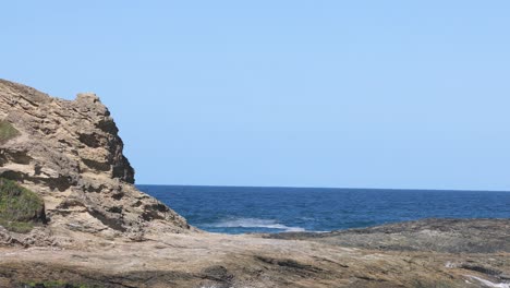 waves crashing against a rocky seaside cliff