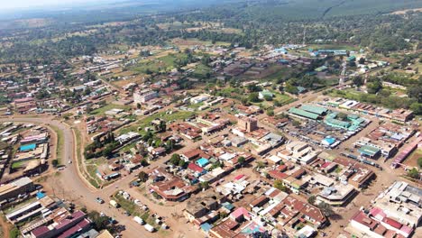 Aerial-view-of-cars-and-people-at-a-Open-Air-Market,-in-Africa---reverse,-drone-shot