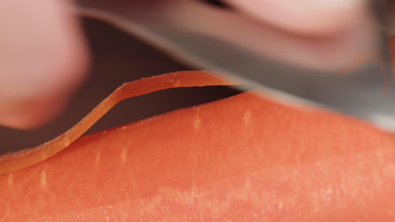 Close-up of a Hand Peeling a Fresh Carrot