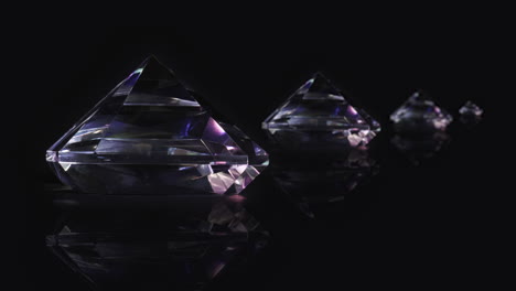 multiple priceless diamond crystal gemstones spin on black background